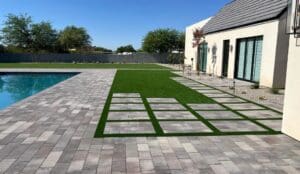 artificial turf and paver patio by pool installation